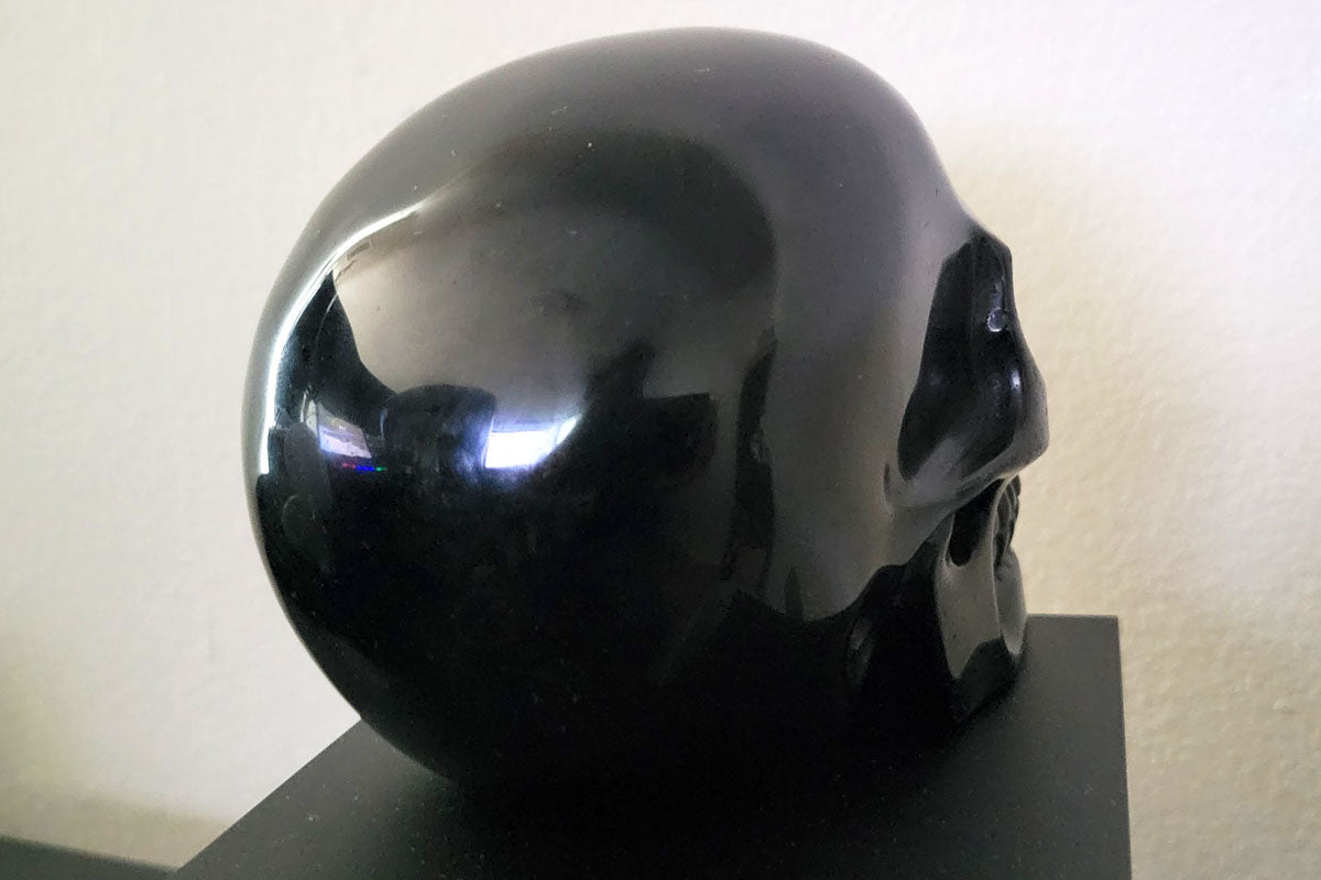 Large black obsidian crystal skull used for energy work and meditation